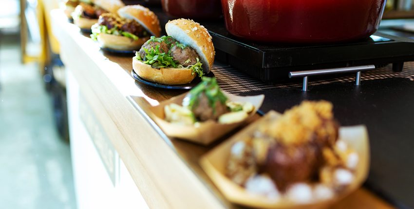 Close-up of bread with different types meatballs in a food truck.